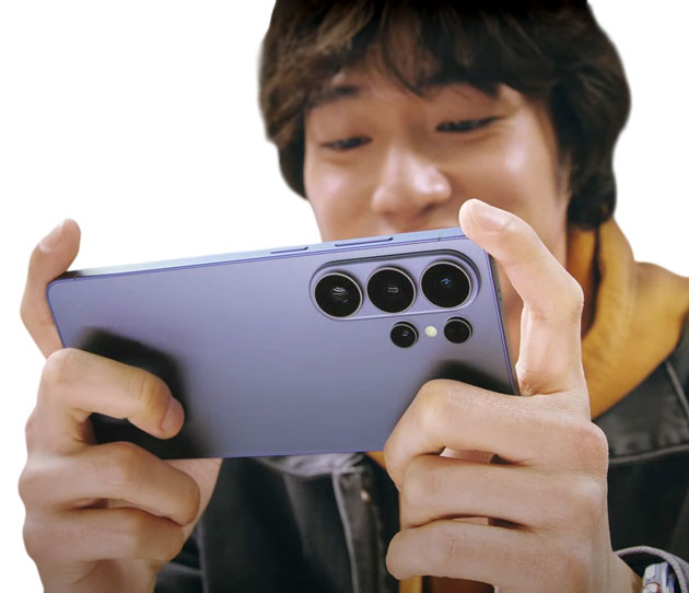 A person holding a Samsung Galaxy S26 Ultra in Cobalt Violet horizontally shows off a redesigned rear camera system that includes three large lenses and two smaller sensors, housed in a separate horizontal oval island.