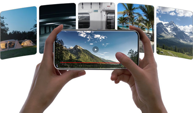A person filming a landscape with the Infinix Note Edge; the screen shows a video player interface with a play button.
