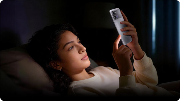 A person using the Infinix Note Edge in a dimly lit room. The screen's 2160Hz PWM dimming technology is active to reduce flicker and eye strain during nighttime use.