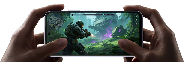 A persons hands holding the OPPO K14x 5G horizontally while playing a high graphics action game showcasing the slim bezels and immersive display A person's hands holding the OPPO K14x 5G horizontally while playing a high-graphics action game, showcasing the slim bezels and immersive display.
