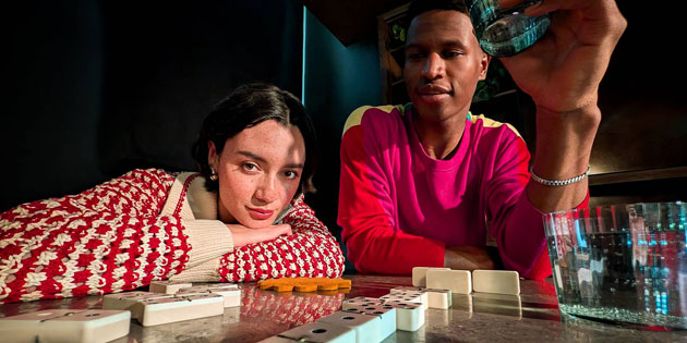 A wide shot taken with the Google Pixel 10 Pro XL camera of two people posing while playing dominoes A wide shot taken with the Google Pixel 10 Pro XL camera of two people posing while playing dominoes