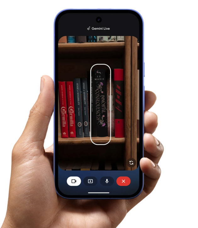 Handheld Google Pixel 10a demonstrating Gemini Live AI identifying a book on a shelf through the camera viewfinder.