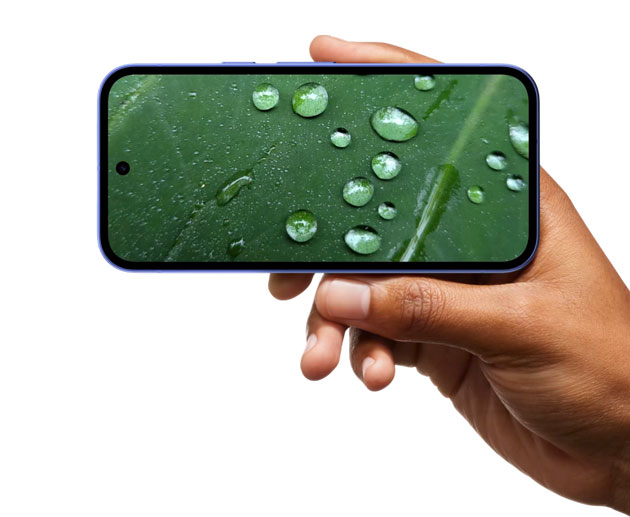 Handheld Google Pixel 10a in landscape mode displaying a detailed macro photo of a green leaf with water droplets.