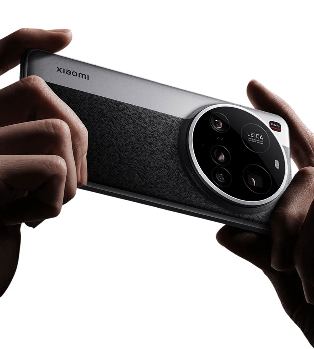 A close up of the back of the Xiaomi 15 Ultra held in a hand. The phone has a matte dark textured back panel and a large circular camera module with Leica branding A close-up of the back of the Xiaomi 15 Ultra held in a hand. The phone has a matte, dark textured back panel and a large, circular camera module with Leica branding.
