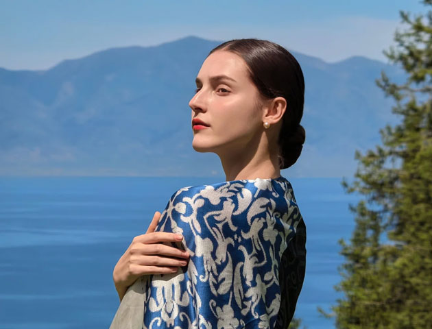 A close up portrait taken with the Huawei Pura 80 Ultra showing a woman in profile against a blurred mountain lake background A close-up portrait taken with the Huawei Pura 80 Ultra showing a woman in profile against a blurred mountain lake background.