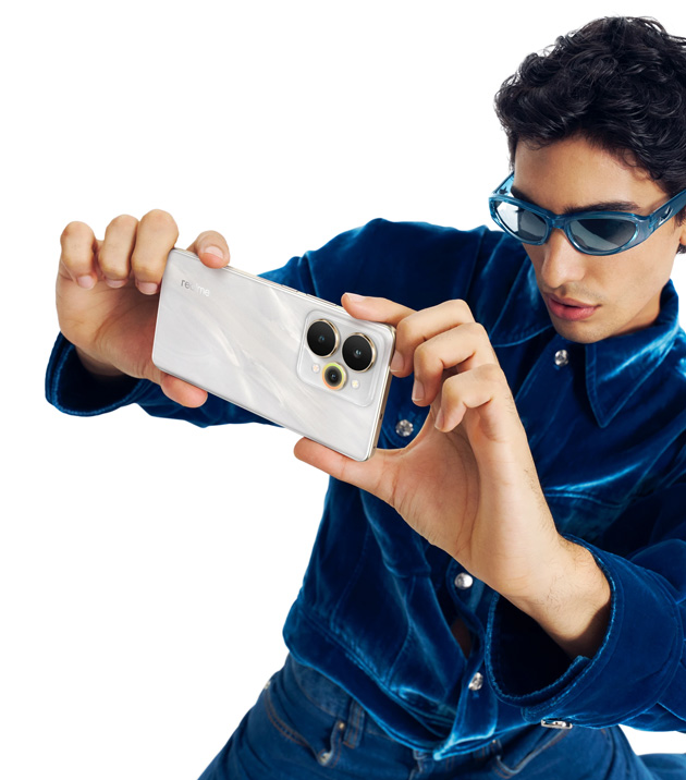 A man holds a Realme 15 Flowing Silver A man holds a Realme 15 Flowing Silver