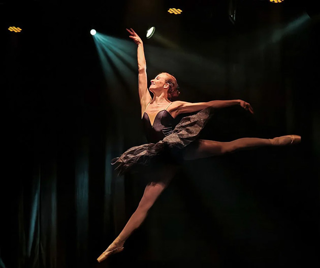 A sharp action shot captured on the Xiaomi 15 Ultra showing a ballerina in a dark tutu mid leap on a stage A sharp action shot captured on the Xiaomi 15 Ultra showing a ballerina in a dark tutu mid-leap on a stage.