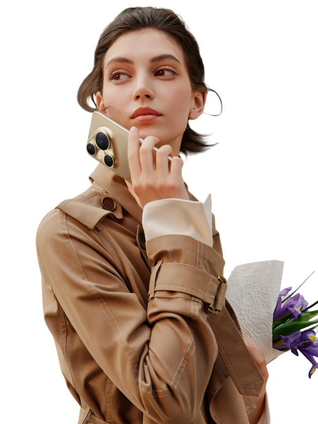 A woman in a tan trench coat holding the Huawei Pura 80 Ultra Prestige Gold A woman in a tan trench coat holding the Huawei Pura 80 Ultra Prestige Gold.