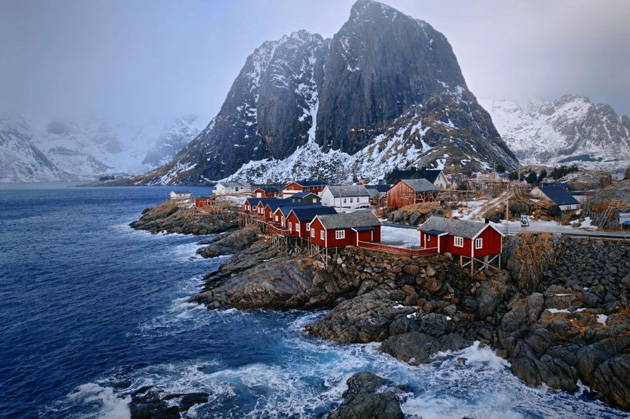 A coastal village with red houses and snow-covered mountains; photo taken with OPPO Find X9 Ultra camera