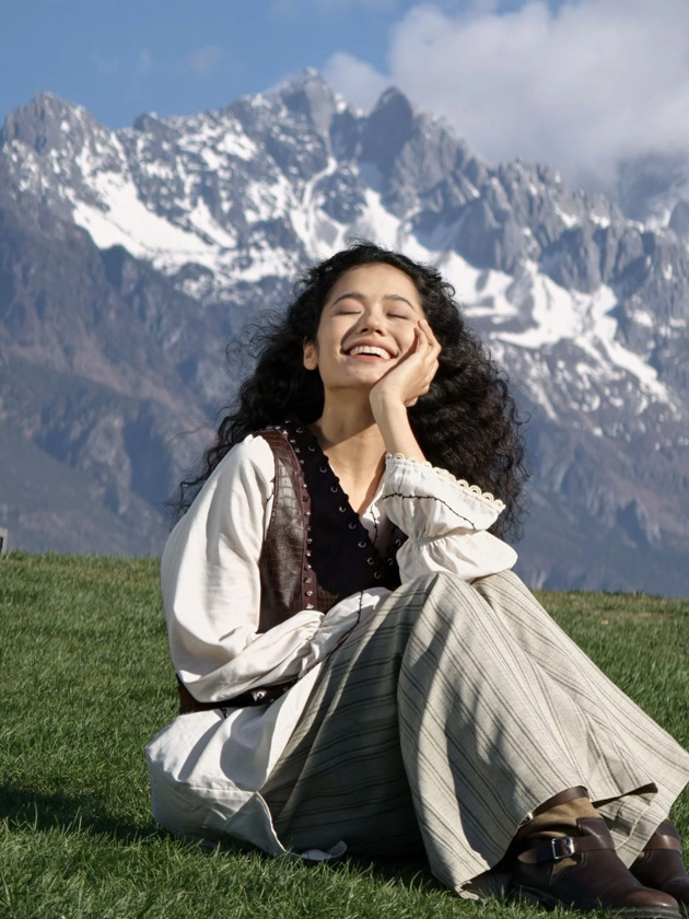 An outdoor portrait on grass with a background of snowy mountains; photo taken with OPPO Find X9 Ultra camera