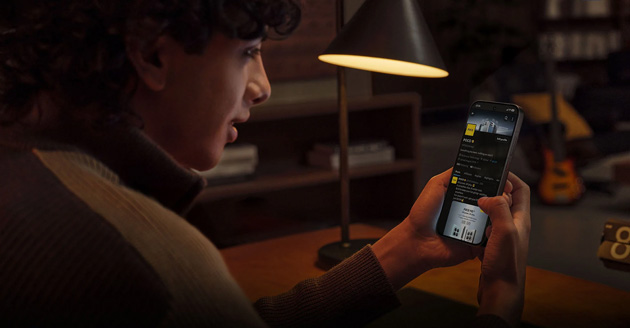 Person using a Poco X8 Pro in a dimly lit room, with the screen clearly visible.