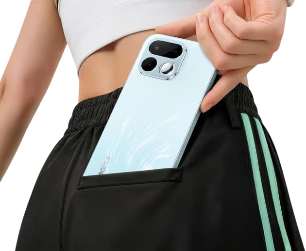 Realme 16T Aurora Green tucked into the back pocket of athletic shorts.