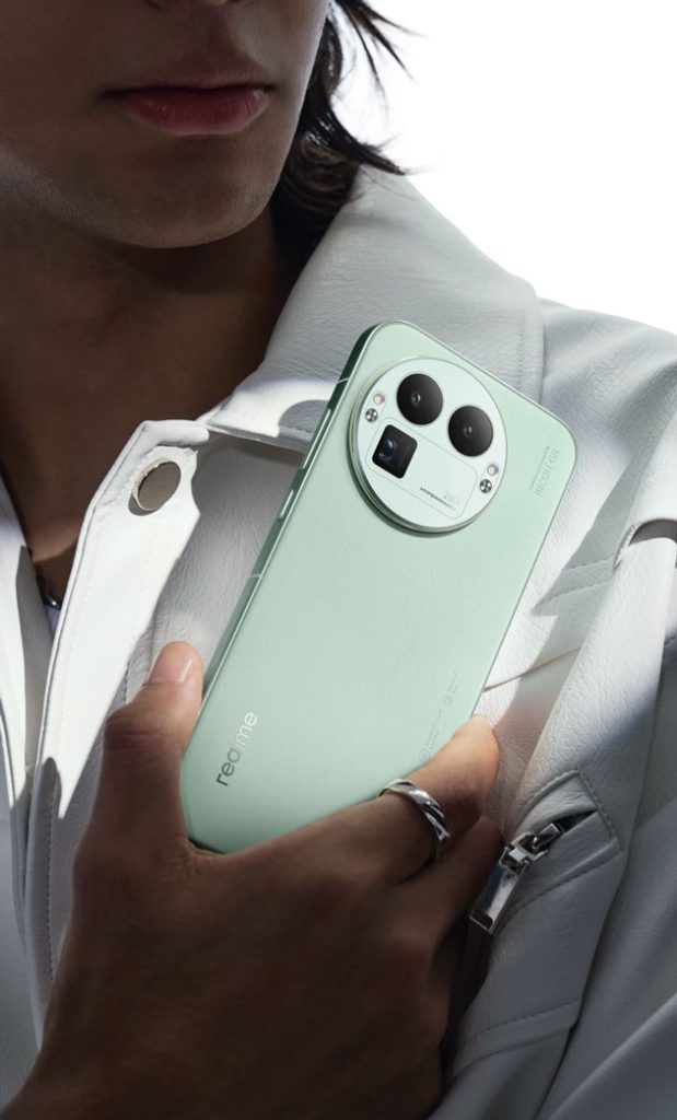 Realme GT 8 Pro held in hand with a close up of the green back panel and the large circular camera module.