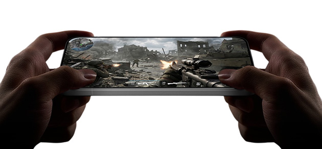 View of a shooter game running on the Xiaomi Redmi K90 Max in landscape mode while holding the device with both hands.