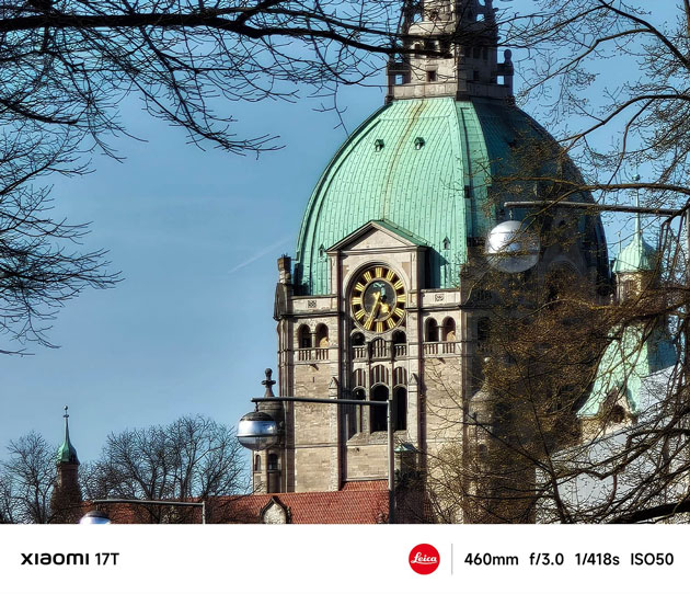 A photo taken with the Xiaomi 17T's advanced zoom, capturing a historic building's green dome and clock tower.